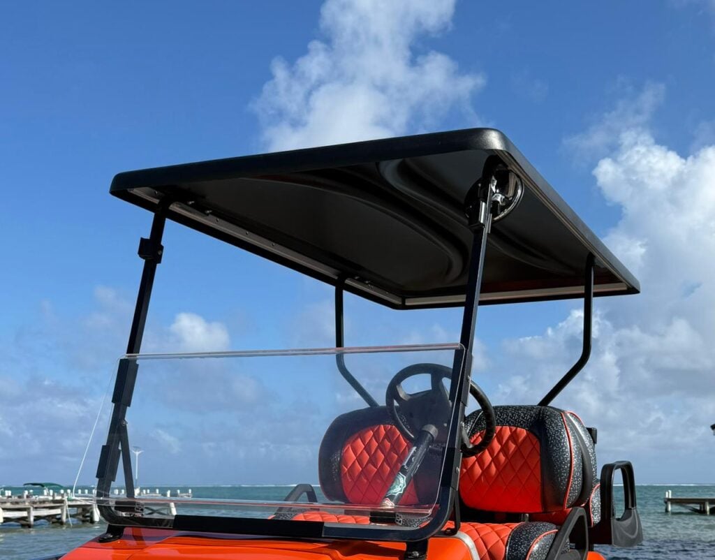 Golf cart with extended roof providing shade in San Pedro, Belize